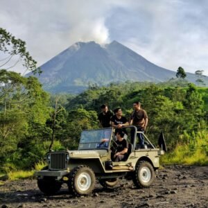 Group enjoying an off-road adventure near Mount Merapi volcano, surrounded by lush greenery.